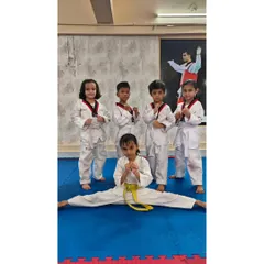 Flexibility and fun go hand in hand. While some of our youngest students practice their fighting stance, another shows off her impressive split, demonstrating the flexibility we build in our classes.