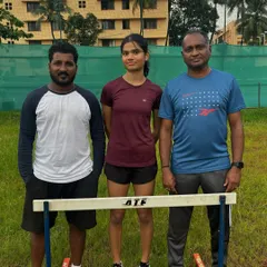 A state-level hurdles silver medalist with her coaches. This represents the successful outcome of our focused hurdle training program.