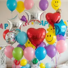 I offer a huge variety of balloons to fit any party theme or color scheme. This image shows a mix of latex balloons and foil balloons in heart, star, and smiley face shapes.