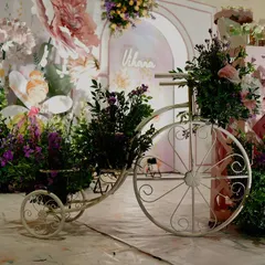 A vintage-style tricycle overflowing with flowers adds a touch of rustic charm to this fairytale garden party. I use a variety of props to add layers and texture to the overall event design.