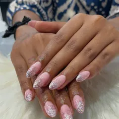 A different view of the glitter gradient extensions, showing how the sparkle catches the light. The seamless blend of the glitter into the pink base is key to making this look so polished and professional.