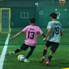 A glimpse into a competitive training match. Here, two players battle for the ball, showcasing the speed and skill that we cultivate in our academy. This is where game-changers are made.
