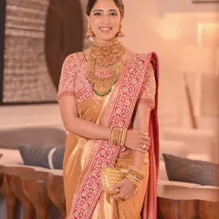 The complete look of this elegant bride, with her hair perfectly styled to complement her temple jewellery and silk saree.