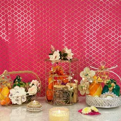 A beautiful display of my diverse Diwali hamper collection. You can see the golden birdcage hamper, a silver crystal-top basket, and a golden mesh basket, each curated with a unique assortment of dry fruits, sweets, and decorative diyas.