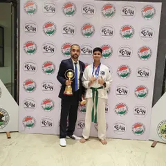 Celebrating a major win with my student, who is holding a championship trophy and his medals. Moments like these are a testament to his perseverance.