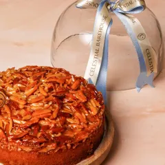 Meet our Honey Almond Crunch Cake. It’s a soft, buttery cake made with wholesome ingredients and topped with a layer of crunchy, honey-caramelized almonds. We present it with our signature glass cloche, which you can keep long after the cake is gone.