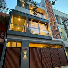A night view of our compact urban residence in South Bengaluru. We designed this 4BHK home on a 750 sqft plot, using strategic lighting and a vertical brick jali to create a striking facade with great curb appeal.