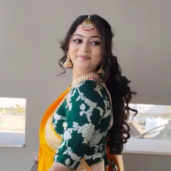 A side profile of the bride, showing off her beautiful smile and the soft, romantic hairstyle.