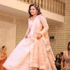 A twirl of happiness for this engagement bride. Her pink chikankari lehenga was complemented by a soft, romantic makeup look with loose curls and floral accessories, making her look like a princess.