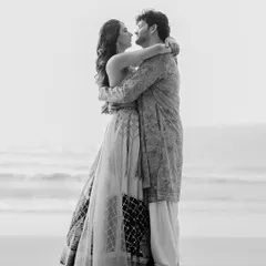 Rupanshi and Yash embracing by the sea, captured in beautiful black and white. This image feels classic and focuses entirely on their connection.