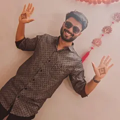 A happy groom celebrating his mehendi ceremony, proudly displaying his simple yet significant henna designs.