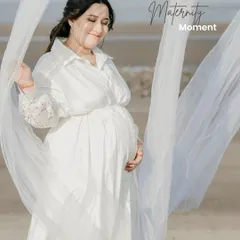 Using a simple, flowing white fabric, we can add a touch of softness and movement to your beach maternity photos. This mom-to-be looks so peaceful and content.