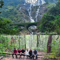 A two-part image showing the grand Dudhsagar falls and a group of our trekkers resting on a log in the forest during the trek.