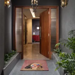 A striking entryway with a bold red console table set against a dark, textured wallpaper. The design makes a dramatic and stylish first impression.
