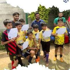 A full team of young players proudly displays their certificates and trophy after a successful tournament. I believe celebrating these achievements is key to building confidence and motivating players for future challenges.