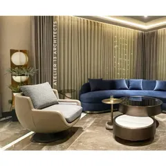 Designed for a family in Shanti Niketan, this lounge combines a bold curved blue velvet sofa with a sleek nesting table and a beige swivel armchair. The composition creates a perfect blend of warmth and contemporary sophistication.