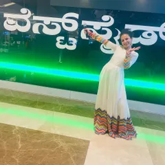 Anchor Nisarga Gowda looking cheerful in our white and multi-color chevron gown while hosting a mall event. This outfit is available for rent.