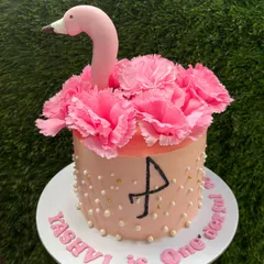 A tropical flamingo cake for a first birthday. This design uses fresh pink carnations to create the flamingo's feathers, with minimal fondant for a beautiful and delicious result.