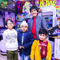 A group of friends posing for a photo in the middle of the arcade. It's a great place for kids to bond and make new friends over some friendly competition.