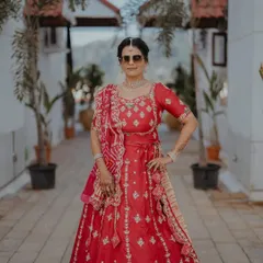 The groom's beautiful mom, looking regal and proud. We went for a classic look that complemented her stunning red lehenga.
