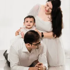 This composition creates a lovely, layered family portrait. The clean white background allows the family's connection and joy to be the central story of the photograph.