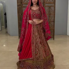 This pre-loved maroon velvet lehenga offers a rich, royal look. The full-length shot showcases the beautiful paisley embroidery and the luxurious feel of the velvet fabric.