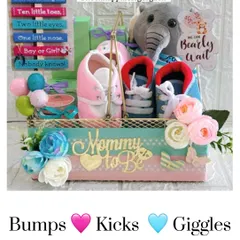A full view of my popular "Bumps, Kicks, Giggles" baby shower hamper. It includes both pink and blue booties, a plush toy, and a decorative sign, making it a wonderful centerpiece for a gender-reveal party.