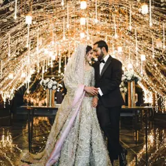 Under a canopy of twinkling fairy lights, I capture the quiet moments of connection. This reception shot shows the blend of luxury decor and genuine intimacy, creating a timeless portrait of the couple lost in their own world.