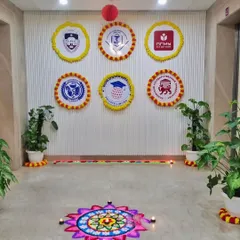 For Diwali, I create a festive and welcoming environment. Here you can see a beautiful rangoli at the entrance, complemented by custom company logos framed with marigold flowers to blend branding with tradition.