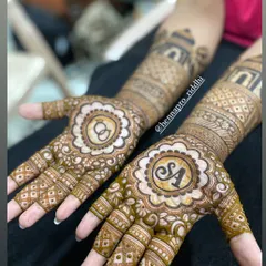 Engagement henna is always special. This design features the couple's initials and the infinity symbol for their everlasting love, set within beautiful floral mandalas on the palms.