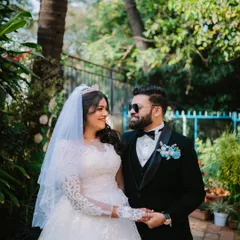 A stylish portrait of the bride and groom, with the groom wearing sunglasses for a cool, modern touch to their Christian wedding photos.