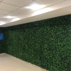 Even a simple office corridor can be made more engaging. We covered the walls of this hallway with our boxwood panels, turning a plain walkway into a more pleasant and vibrant space.