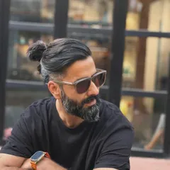 The man bun look, executed with a sharp undercut. This style keeps the sides and back neat and tidy while allowing for length and styling versatility on top.