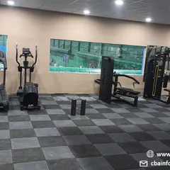Our cardio section includes treadmills and elliptical trainers, essential for building the cardiovascular endurance needed to sustain long matches. The gym overlooks the courts, creating an integrated training environment.