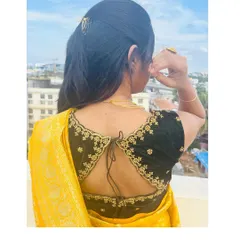 A beautiful black velvet blouse with gold floral embroidery along the back. The tie-up detail adds a traditional touch.
