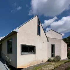 The simple, gabled forms of the 'Wildgrass' home, which settle quietly into the Nilgiri hills. The design uses clean lines and a muted color palette to complement, rather than dominate, the natural beauty of the site.