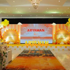 We love creating grand and immersive experiences. For this sunshine-themed naming ceremony, we designed a full stage setup with a vibrant LED screen backdrop, custom sun-shaped props, and cheerful balloon garlands to welcome baby Aryaman.