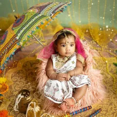 A full view of the vibrant Navratri setup, with rich fabrics, festive props, and a beautifully dressed baby girl ready to celebrate.