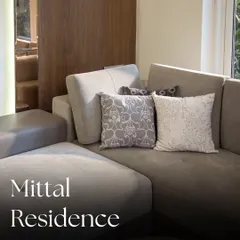 A closer look at the custom details in the Mittal Residence. The hand-embroidered cushion covers add a touch of color and intricate detail, serving as beautiful accent pieces against the neutral grey tones of the Copenhagen Sofa.