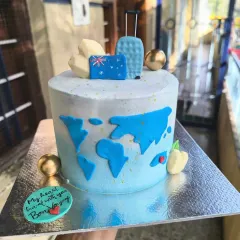 A bon voyage cake for a travel enthusiast. This design features a world map, fondant suitcases, and an Australian flag to celebrate an exciting journey ahead.