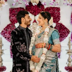 A candid moment from a beautiful baby shower we decorated. The couple is framed by our intricate floral backdrop of purple and white flowers, showing how our designs create the perfect setting for cherished memories.