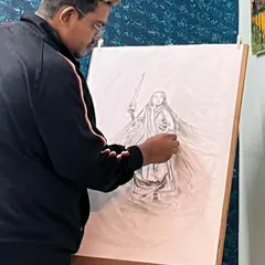 Here I am, working on a detailed graphite pencil drawing on an easel. In my classes, I guide students through the process of creating larger, more complex compositions.
