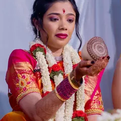 My client Vasuda during her Varapooja. Her dark, polished nails complemented her beautiful pink and orange saree and traditional jewelry.