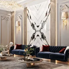 This living room design features classic wall molding and a striking book-matched marble accent wall. The deep blue velvet sofas add a touch of color and luxury to the neutral space.