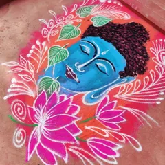 A serene Buddha face rangoli, surrounded by lotus flowers and Bodhi leaves. I used bright colors to create a peaceful and welcoming design.