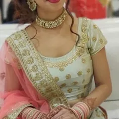 A close-up of the pista green blouse, showing the delicate embroidery around the neckline. This outfit is perfect for a sangeet or mehndi function.