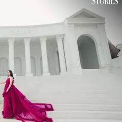 Using the grand steps of a library-style building to frame the bride's magnificent gown. This low-angle shot adds a sense of scale and drama to the pre-wedding portrait.