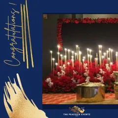 Details matter in creating the perfect ambiance. This setup for a Sangeet features a dramatic arrangement of red flowers and tall candle stands, adding a touch of romance and sophistication to the stage area.