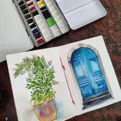 A watercolor sketch of a potted plant next to a beautiful blue door. This is from my travel sketchbook, where I capture interesting architectural details and scenes.