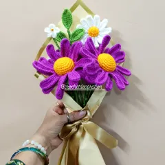 A vibrant bouquet featuring bold purple oxeye daisies and classic white daisies, beautifully wrapped and ready for gifting. Each petal is carefully stitched to create a realistic and lasting floral gift.